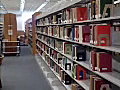 RoyaltyFreeStockVideoSDFootageZoomOutShotofLibraryBooksonShelvesandStudentsStudyinginFortLauderdaleFlorida