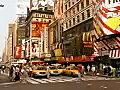 RoyaltyFreeStockVideoSDFootagePeopleCrossStreetinTimesSquareonaHotHazyDayinNewYorkCity